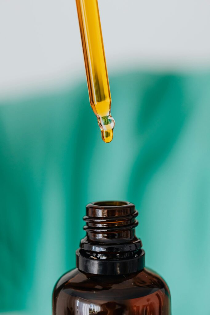 pexels-photo-4021773-4021773 Detailed view of an amber glass bottle and dropper used in laboratory or medical setting, illustrating chemical experimentation.